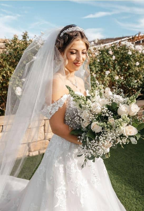 beautiful bride holding a white rose bouquet