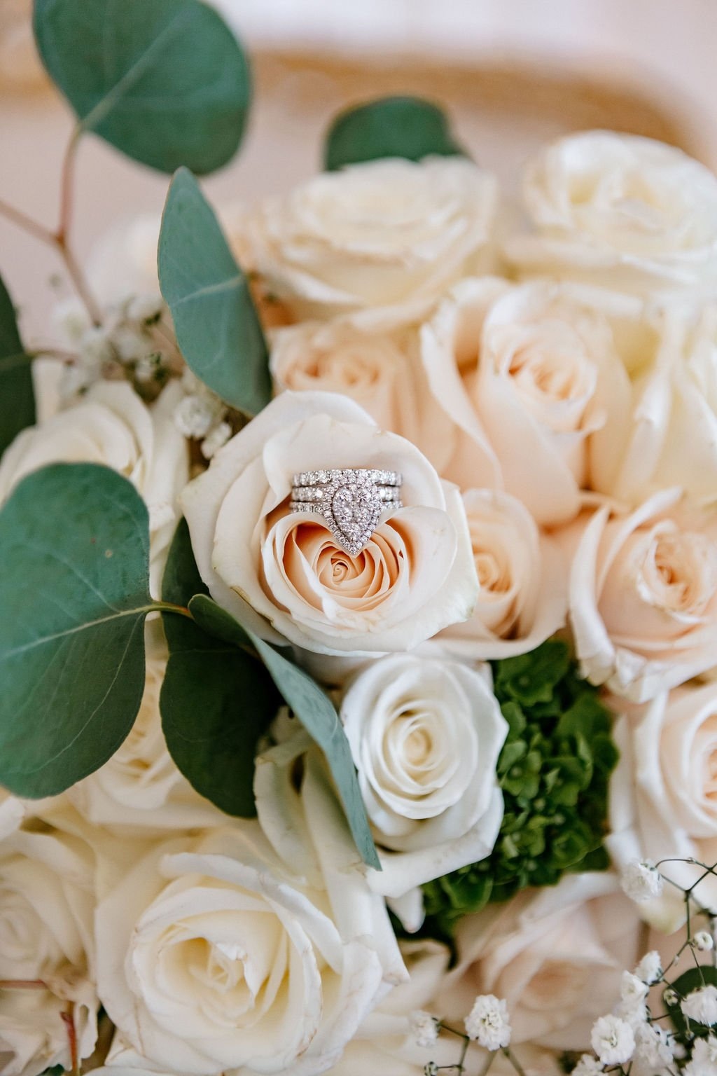 Close-up of a wedding ring nestled in a bridal bouquet, showcasing the detail-focused work of wedding photographers in San Francisco and the moments they capture.